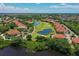 Gorgeous aerial view of a golf community with vibrant green courses and beautiful homes with terracotta roofs at 661 Foggy Morn Ln, Bradenton, FL 34212