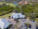 Aerial view of a country club with water and trees surrounding the property at 661 Foggy Morn Ln, Bradenton, FL 34212