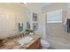 Well-lit bathroom features a granite countertop, neutral tile, and a combined shower and bathtub at 661 Foggy Morn Ln, Bradenton, FL 34212