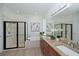 Elegant bathroom with double sinks, a soaking tub, and a glass-enclosed shower at 661 Foggy Morn Ln, Bradenton, FL 34212