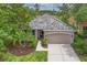 Charming home featuring a tile roof, two-car garage, well-maintained landscaping, and a welcoming walkway at 661 Foggy Morn Ln, Bradenton, FL 34212