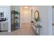 Inviting hallway features modern decor, stylish console tables, and a view towards the front door at 661 Foggy Morn Ln, Bradenton, FL 34212