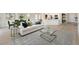 Open-concept living room with modern decor, sleek furniture, and lots of natural light at 661 Foggy Morn Ln, Bradenton, FL 34212