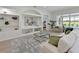 Well-lit living room featuring built-in shelves, modern furniture, and an open layout, perfect for entertaining at 661 Foggy Morn Ln, Bradenton, FL 34212