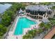 Aerial view of large pool surrounded by chairs and greenery and a view of the water at 661 Foggy Morn Ln, Bradenton, FL 34212
