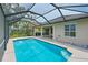 Sparkling pool with screened-in enclosure and outdoor kitchen, perfect for outdoor entertaining at 661 Foggy Morn Ln, Bradenton, FL 34212
