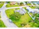 Aerial view of home with a lush green lawn, mature trees, and neighboring houses at 6627 Heritage Ln, Bradenton, FL 34209