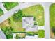 Overhead view of a home with a gray roof, green lawn, and several trees surrounding the property at 6627 Heritage Ln, Bradenton, FL 34209