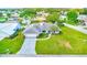 An aerial view shows the house and its surroundings in a neighborhood with lush green lawns at 6627 Heritage Ln, Bradenton, FL 34209