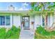 Inviting entrance with decorative plants, stone columns, and a charming tree at 6627 Heritage Ln, Bradenton, FL 34209