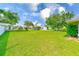 Front view of a house with a green lawn and trees, captured on a sunny day with blue skies at 6627 Heritage Ln, Bradenton, FL 34209