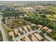 A scenic aerial shot showcases a residential area near a lake, golf course, and mature trees at 6764 Hickory Hammock Cir, Bradenton, FL 34202
