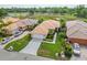 High angle view features a charming home with lush landscaping, a tile roof, and a spacious driveway at 6764 Hickory Hammock Cir, Bradenton, FL 34202