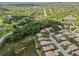 A picturesque aerial view captures a neighborhood surrounded by lush trees, a golf course, and lakes at 6764 Hickory Hammock Cir, Bradenton, FL 34202