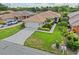 Aerial view of a charming home with lush landscaping, a tile roof, and a spacious driveway at 6764 Hickory Hammock Cir, Bradenton, FL 34202