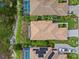 Aerial view of homes featuring tile roofs, screened-in pools, solar panels, and lush landscaping at 6764 Hickory Hammock Cir, Bradenton, FL 34202