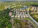 A scenic aerial shot shows a neighborhood with tile roofs near a golf course and lake at 6764 Hickory Hammock Cir, Bradenton, FL 34202