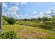 Beautiful backyard view overlooking a serene landscape with lush greenery and a bright blue sky at 6764 Hickory Hammock Cir, Bradenton, FL 34202