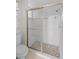 Bright bathroom featuring a glass-enclosed shower with a mosaic tile floor and decorative accent tiles at 6764 Hickory Hammock Cir, Bradenton, FL 34202