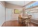 Dining area with tiled flooring, large window, and a simple light fixture at 6764 Hickory Hammock Cir, Bradenton, FL 34202