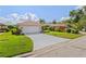 Charming single-story home with a tile roof, two-car garage, and meticulously maintained landscaping at 6764 Hickory Hammock Cir, Bradenton, FL 34202