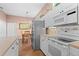 Open kitchen showcasing white cabinetry, stainless appliances, and a functional island with a breakfast area at 6764 Hickory Hammock Cir, Bradenton, FL 34202