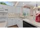 Bright kitchen features white cabinets, stainless steel appliances, neutral countertops, and a breakfast bar at 6764 Hickory Hammock Cir, Bradenton, FL 34202
