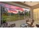 This screened-in lanai features outdoor seating with scenic sunset views of the surrounding greenery at 6764 Hickory Hammock Cir, Bradenton, FL 34202