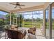 Screened in lanai showing outdoor seating with a beautiful view overlooking a lush green field at 6764 Hickory Hammock Cir, Bradenton, FL 34202