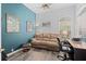 Comfortable living room with hardwood floors, a pullout sofa, and a large sun-filled window with blinds at 6764 Hickory Hammock Cir, Bradenton, FL 34202