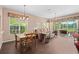 Open-concept living area with wood floors and sliding doors to the lanai, perfect for indoor-outdoor living at 6764 Hickory Hammock Cir, Bradenton, FL 34202
