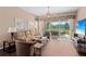 Cozy living room featuring wood floors, neutral paint, a ceiling fan, and sliding glass doors to lanai at 6764 Hickory Hammock Cir, Bradenton, FL 34202
