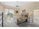 A spacious main bedroom featuring a private balcony, plush carpet, and an attached bathroom at 6764 Hickory Hammock Cir, Bradenton, FL 34202