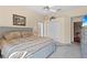 Comfortable bedroom with neutral walls, plush carpet, and a view into the attached bathroom at 6764 Hickory Hammock Cir, Bradenton, FL 34202
