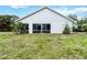Back exterior of home with minimal landscaping at 7 Arbor Oaks Dr, Sarasota, FL 34232