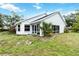 Rear exterior view of home highlighting the sunroom and backyard at 7 Arbor Oaks Dr, Sarasota, FL 34232
