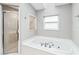 Bathroom showcasing a luxurious soaking tub and separate glass-enclosed shower at 7 Arbor Oaks Dr, Sarasota, FL 34232