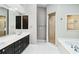Bathroom featuring double sinks, a glass-enclosed shower, and a separate soaking tub at 7 Arbor Oaks Dr, Sarasota, FL 34232