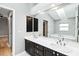 Bathroom featuring double sinks, a large mirror, and a separate soaking tub at 7 Arbor Oaks Dr, Sarasota, FL 34232