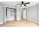 Bedroom featuring wood-look floors, a closet, and a ceiling fan at 7 Arbor Oaks Dr, Sarasota, FL 34232