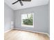 Bright bedroom featuring light-colored floors, a ceiling fan, and a large window for natural light at 7 Arbor Oaks Dr, Sarasota, FL 34232