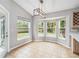 Sunlit breakfast nook with bay windows offering picturesque views of the landscaped yard at 7 Arbor Oaks Dr, Sarasota, FL 34232