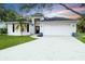 Charming one-story home with a well-maintained lawn and two car garage at 7 Arbor Oaks Dr, Sarasota, FL 34232