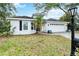 Charming single-story home featuring a manicured lawn, a two-car garage, and classic curb appeal at 7 Arbor Oaks Dr, Sarasota, FL 34232