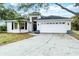 Charming single-story home featuring a manicured lawn, a two-car garage, and classic curb appeal at 7 Arbor Oaks Dr, Sarasota, FL 34232