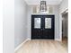 Grand foyer with soaring ceilings, double doors, and light wood floors at 7 Arbor Oaks Dr, Sarasota, FL 34232