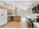 Bright kitchen features stainless appliances, modern cabinets, and a lovely tile floor at 7 Arbor Oaks Dr, Sarasota, FL 34232