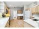 Kitchen with stainless steel appliances, light wood cabinets, tile floors, office nook, and white counters at 7 Arbor Oaks Dr, Sarasota, FL 34232
