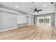 An open living room with sliding doors, ceiling fan, and lots of natural light at 7 Arbor Oaks Dr, Sarasota, FL 34232