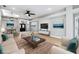 A staged living room featuring neutral tones and a ceiling fan and light fixture at 7 Arbor Oaks Dr, Sarasota, FL 34232